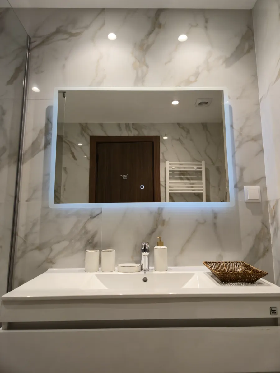Backlit bathroom mirror over the vanity