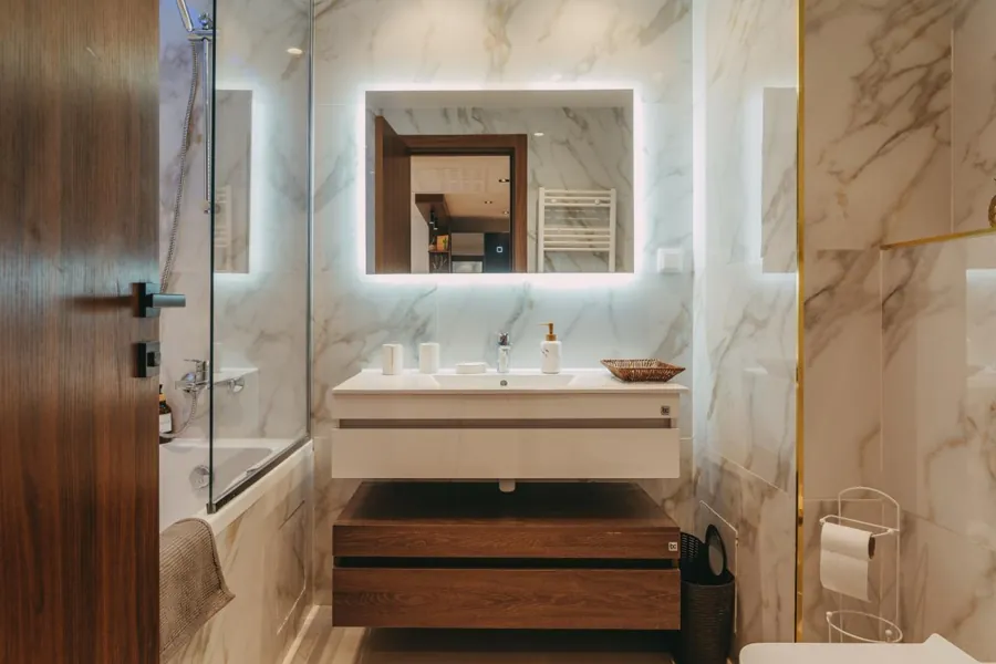 Marble bathroom with backlit mirror