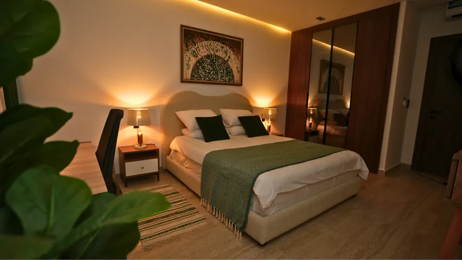 Bedroom at night with warm bedside lighting