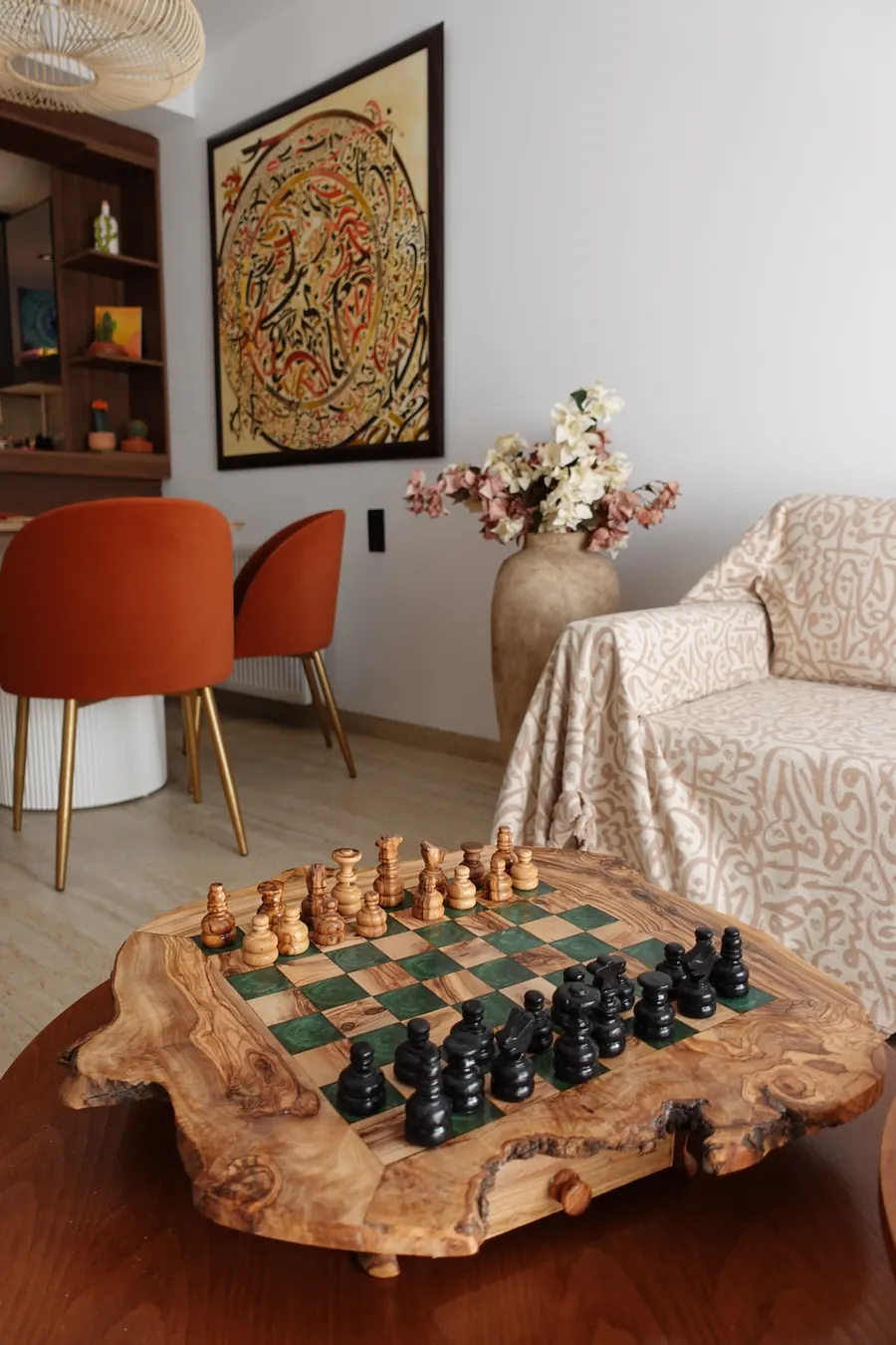 Chess board on a side table next to the sofa and dining chairs