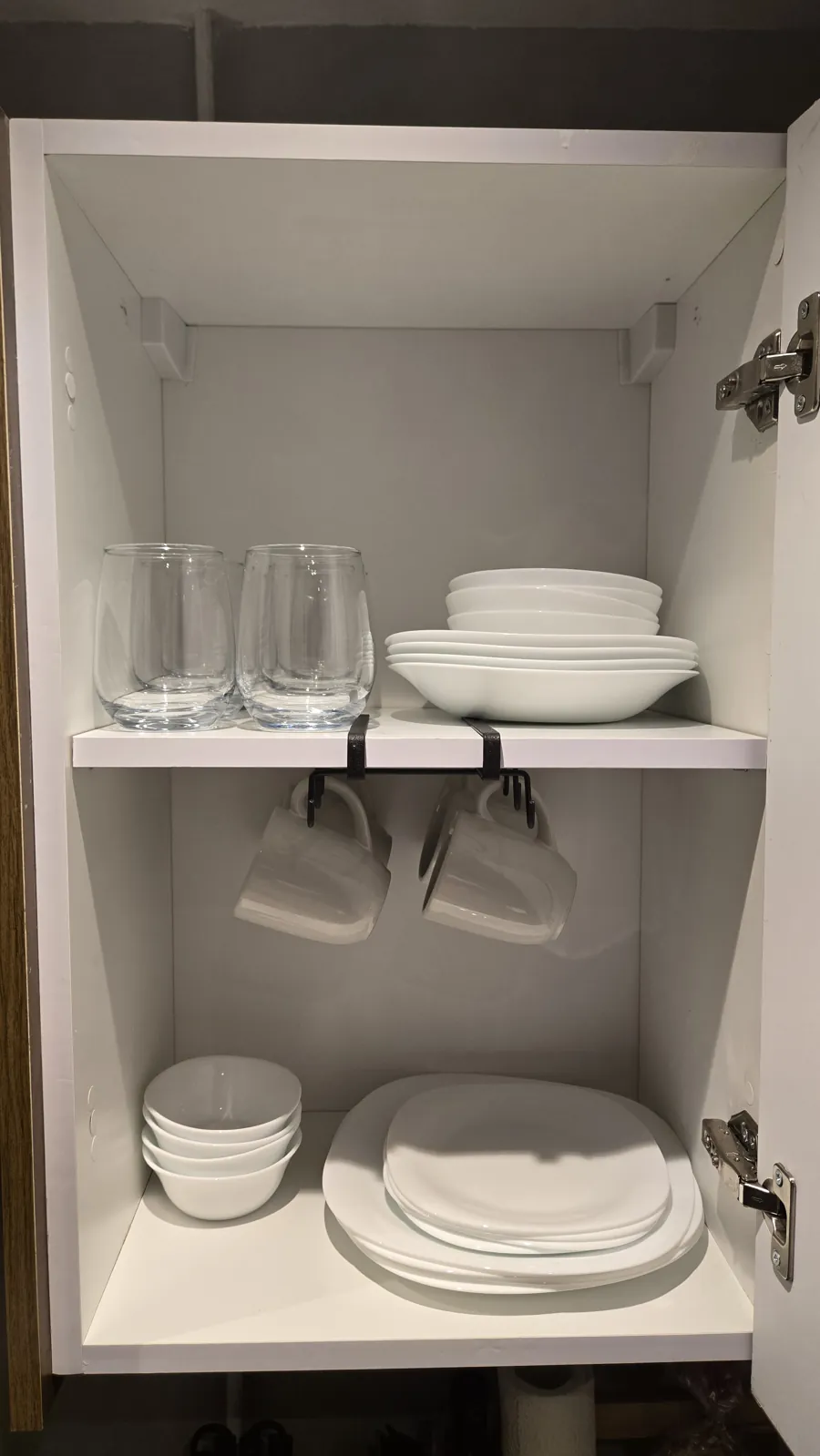 Cabinet stocked with plates, cups and glasses