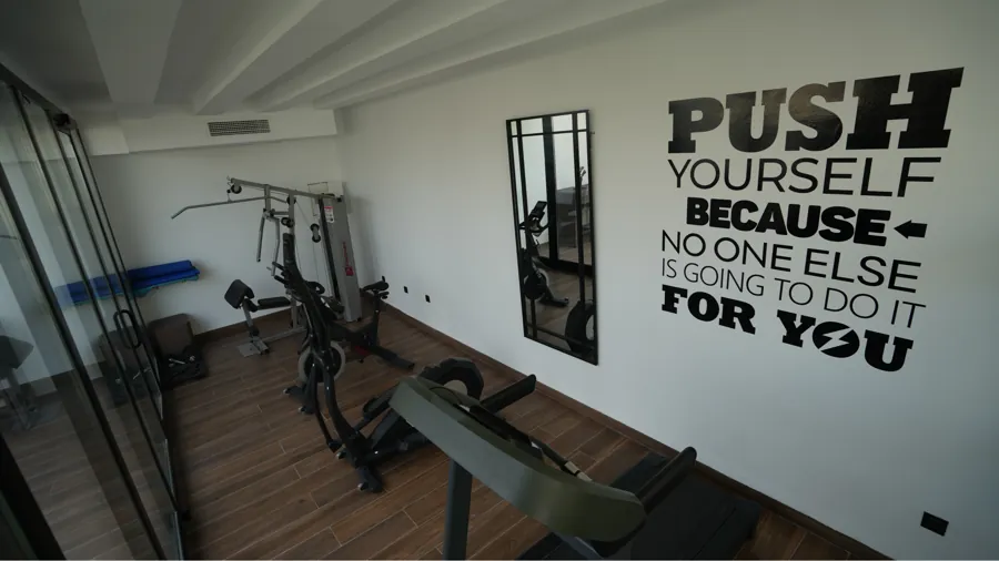 Gym area with weight equipment and motivational wall art