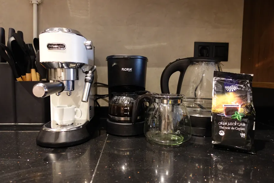 De'Longhi espresso machine, filter coffee maker and kettle on the kitchen counter