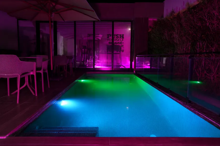 Pool at night with colourful underwater lighting