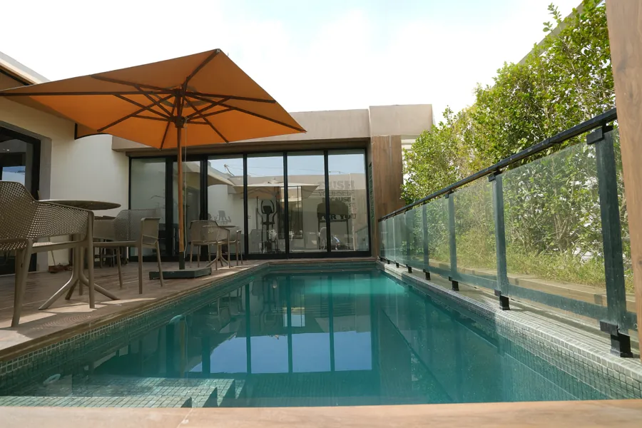 Pool terrace with umbrella and seating